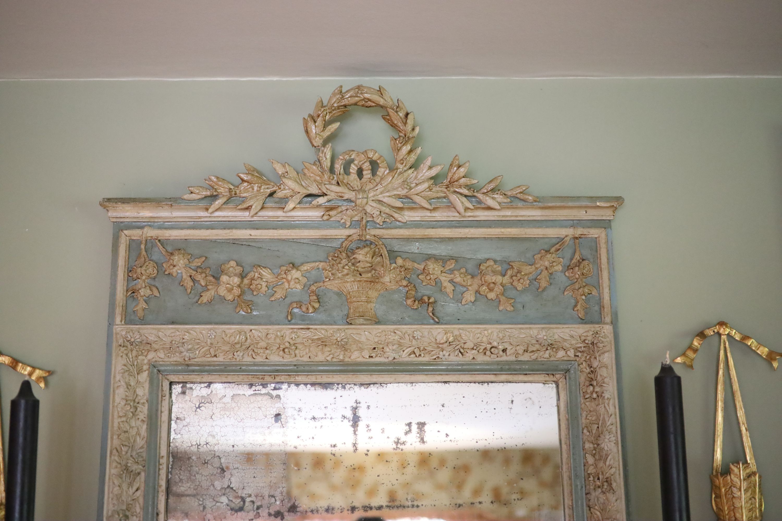 A late 19th century French blue and white painted gesso wall mirror, with laurel and floral basket frieze over a rectangular plate, width 76cm height 134cm